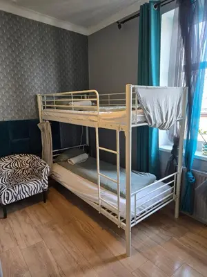 a bedroom with two bunk beds in a room at LOTOS Hostel in Kraków