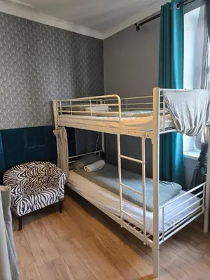 a room with two bunk beds in a room at LOTOS Hostel in Kraków