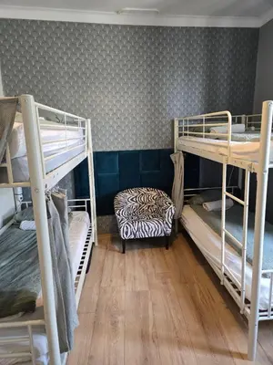 a room with three bunk beds in a dorm at LOTOS Hostel in Kraków