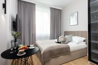 a hotel room with a bed and a table with fruit on it at Green Residence Orawska 5 in Kraków