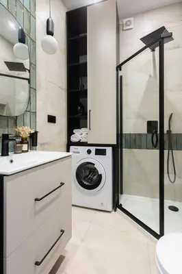 a laundry room with a washer and dryer at Green Residence Orawska 5 in Kraków