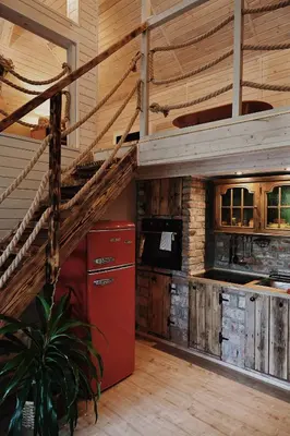 a kitchen with a red refrigerator and a staircase at Ojcowski Zakątek-domek z balią oraz drewniany domek do wynajęcia in Wola Kalinowska