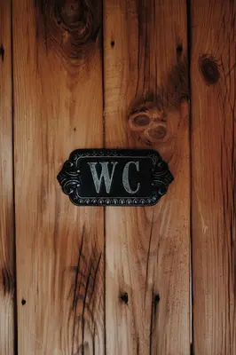 a sign on a wooden door with the letter w on it at Ojcowski Zakątek-domek z balią oraz drewniany domek do wynajęcia in Wola Kalinowska