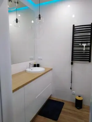 a bathroom with a sink and a mirror at Apartament Premium 72 in Zator