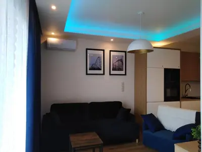 a living room with a couch and a blue ceiling at Apartament Premium 72 in Zator