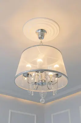 a glass chandelier hanging from a ceiling at Perła Starego Miasta Kamienica Czapskich by Noclegi Renters in Kraków