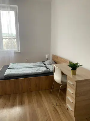 a bedroom with a bed and a desk and a desk at Cracow Old Town Rooms in Kraków