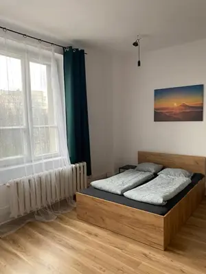 a bedroom with a bed and a window at Cracow Old Town Rooms in Kraków