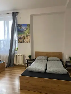 a bedroom with a large bed in a room at Cracow Old Town Rooms in Kraków