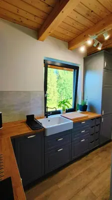 a kitchen with a sink and a window at Górska Ostoja in Sieniawa