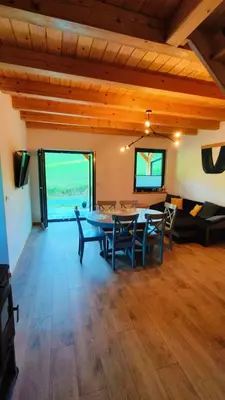 a dining room with a table and chairs and a couch at Górska Ostoja in Sieniawa