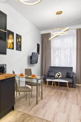 a living room with a couch and a table at Silver Shine jacuzzi in Kraków