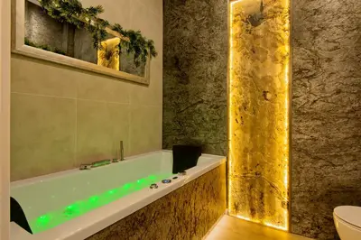 a bathroom with a bath tub with green lights at Silver Shine jacuzzi in Kraków