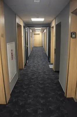 a hallway of an office building with a long corridor at NikoApartments - MiniApartment 2+2 in Kraków