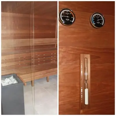 a wooden shower door with a clock on it at NikoApartments - MiniApartment 2+2 in Kraków