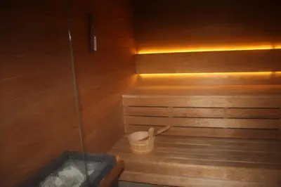 a sauna with a trash can and a bucket in it at NikoApartments - MiniApartment 2+2 in Kraków