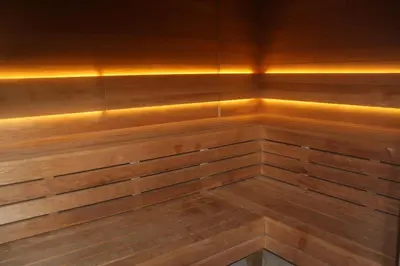 a sauna with wood paneling and led lighting at NikoApartments - MiniApartment 2+2 in Kraków