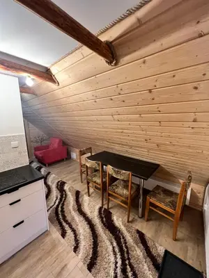 a living room with a table and chairs at Pokoje gościnne 28 w skosie in Zawadka