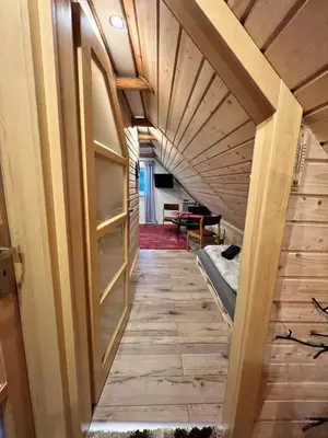 a hallway in a tiny house with a wooden ceiling at Pokoje gościnne 28 w skosie in Zawadka