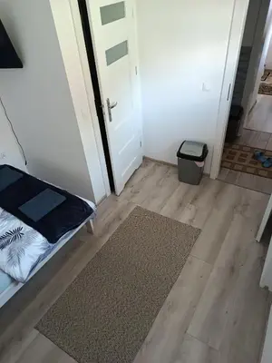 a small room with a door and a rug at Staś-przy szkole nr3 w Skawie in Skawa