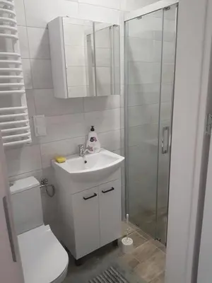 a bathroom with a toilet and a sink and a shower at Staś-przy szkole nr3 w Skawie in Skawa