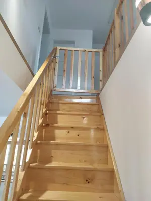 a staircase in a house with wooden steps at Leśny Domek in Las