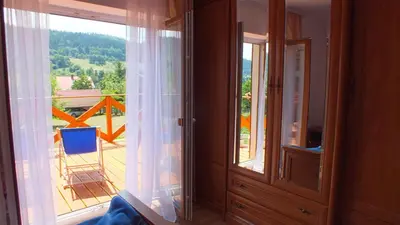 a room with a window and a view of a balcony at Leśny Domek in Las