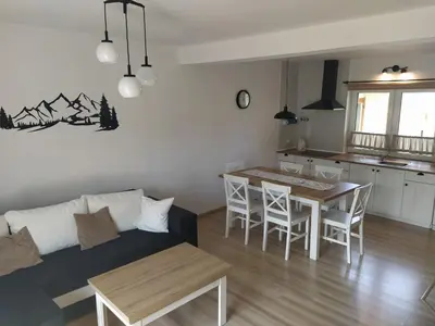 a living room with a couch and a table at Leśny Domek in Las