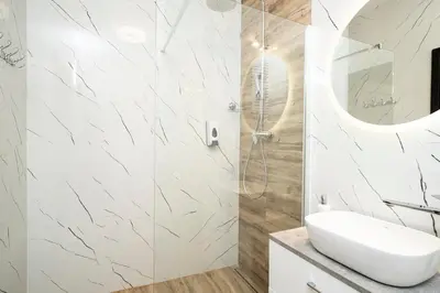 a white bathroom with a sink and a shower at krakow dream apartment in Kraków