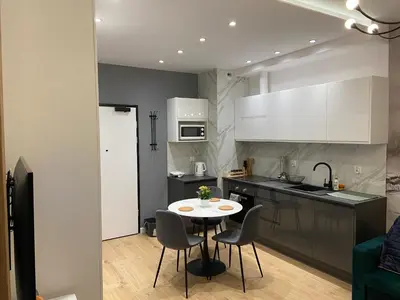 a kitchen with a table and chairs in a room at krakow dream apartment in Kraków