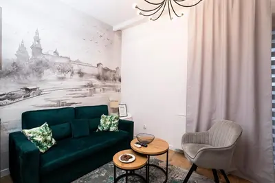 a living room with a green couch and a table at krakow dream apartment in Kraków