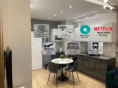 a kitchen with a table and chairs in a room at krakow dream apartment in Kraków