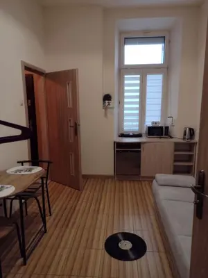 a living room with a couch and a table at Little Big BC - Central Modern Studio in Kraków