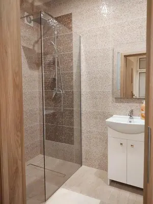 a bathroom with a shower and a sink at Little Big BC - Central Modern Studio in Kraków