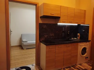 a kitchen with a washer and dryer in a room at Little Big BC - Central Modern Studio in Kraków
