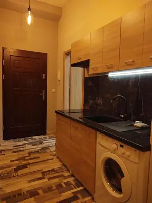 a kitchen with a washing machine and a sink at Little Big BC - Central Modern Studio in Kraków