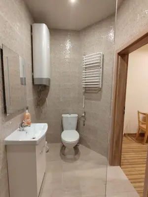 a small bathroom with a toilet and a sink at Little Big BC - Central Modern Studio in Kraków