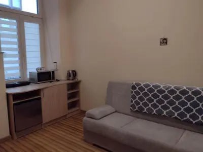 a living room with a couch and a table at Little Big BC - Central Modern Studio in Kraków