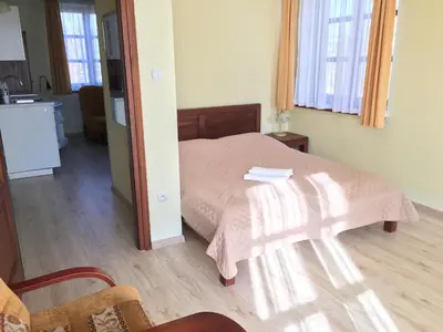 a hotel room with two beds and a tv at Villa Gorczańska in Rabka