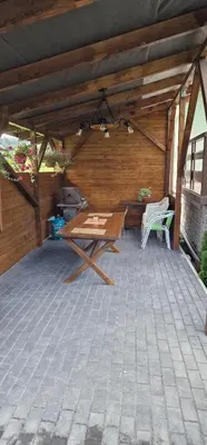 a patio with a picnic table and a bench at Apartament Leśny in Nowy Targ