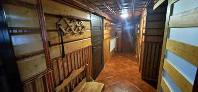 an empty room with a bench and wooden walls at Apartament Leśny in Nowy Targ