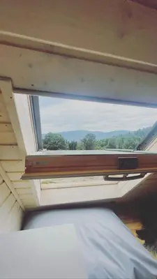 a window above a bed in a room with a view at Chatki Osada Babia Raj Zawoja in Zawoja