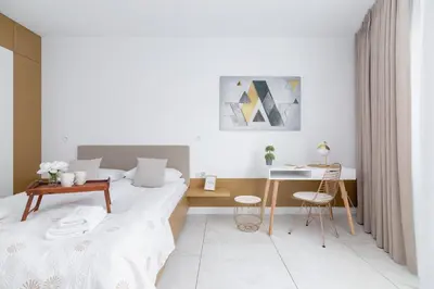 a white room with a bed and a desk at Modern Apartment Cracow Old Town by Noclegi Renters in Kraków