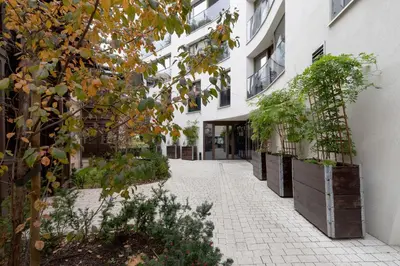 an alley in a building with potted plants at Modern Apartment Cracow Old Town by Noclegi Renters in Kraków