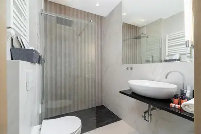 a white bathroom with a sink and a shower at Modern Apartment Cracow Old Town by Noclegi Renters in Kraków