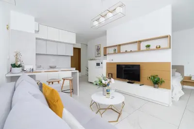 a white living room with a couch and a table at Modern Apartment Cracow Old Town by Noclegi Renters in Kraków