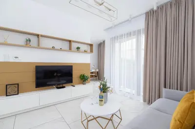 a living room with a tv on a wall at Modern Apartment Cracow Old Town by Noclegi Renters in Kraków