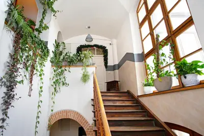 a staircase in a building with lots of plants at Otium Old Town Boutique in Kraków
