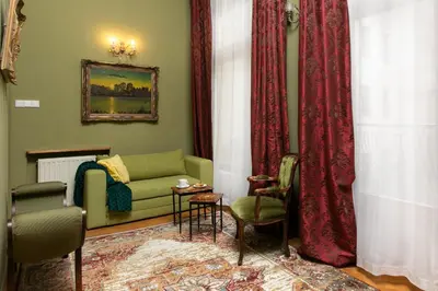 a living room with a couch and a chair at Otium Old Town Boutique in Kraków