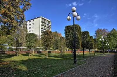 a park with a street light and a building at Czarnowiejska Micro Studio in Kraków